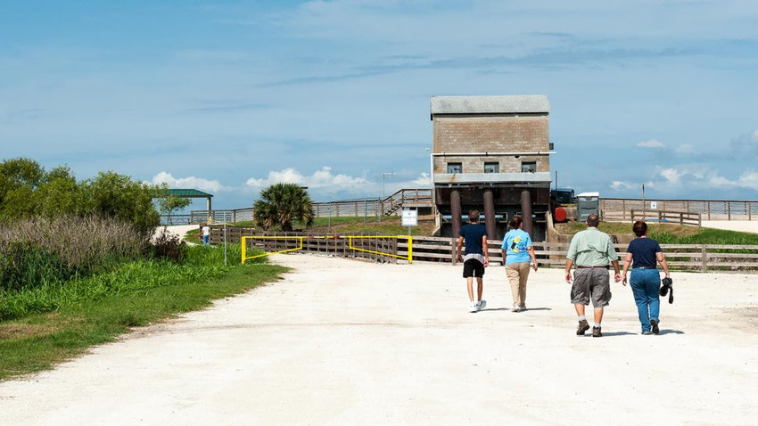 Visitors walk toward the historic pumphouse at the District&rsquo;s Lake Apopka North Shore property.