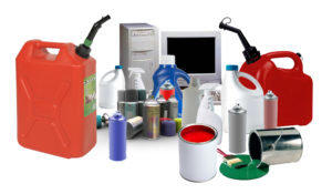 Photo featuring examples of household hazardous and electronic waste: gas cans, cleaners, spray cans, paint, computer and monitor.