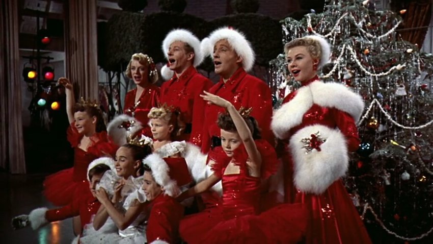 The cast of 'White Christmas' in front of a Christmas tree.
