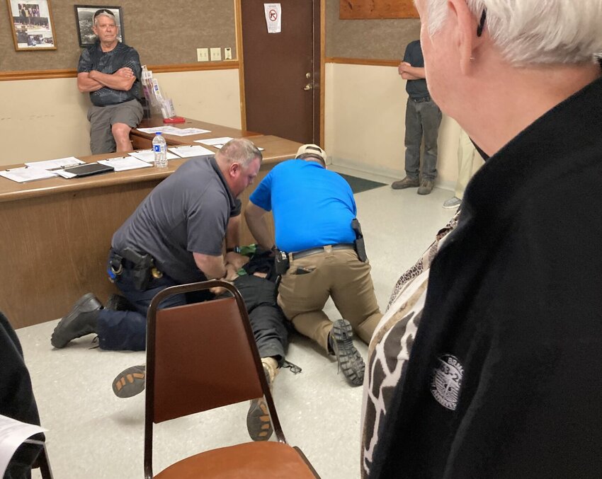 Bull Shoals Police subdue and handcuff an unruly citizen at Tuesday night's special council meeting to consider the resignation of Mayor Michael Savu.


Submitted Photo