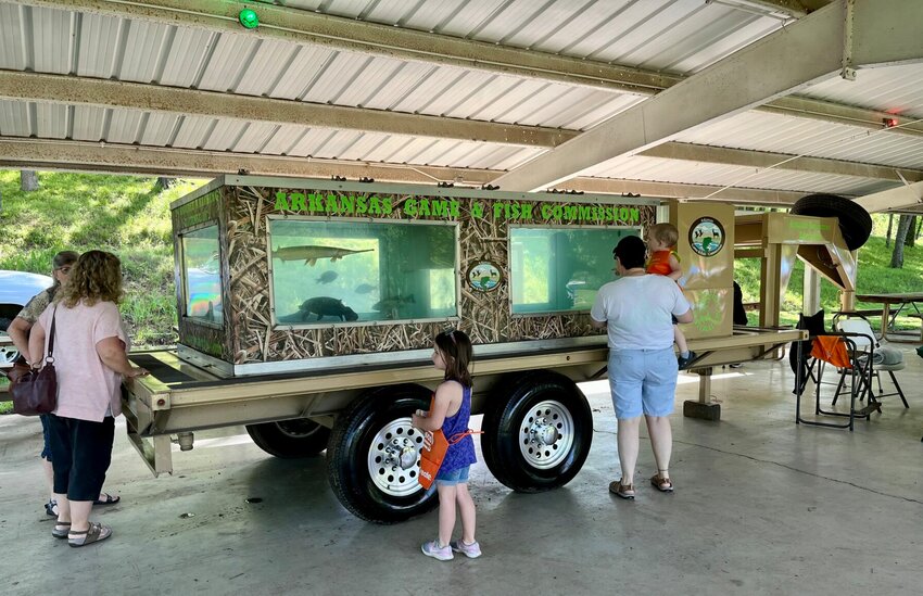 Attendees at the 20th annual Greater Cotter Area Trout Festival held in May of 2022 are shown viewing an AGFC exhibit at Big Spring Park. This year's edition of the annual event is slated for Saturday.


Bulletin File Photo