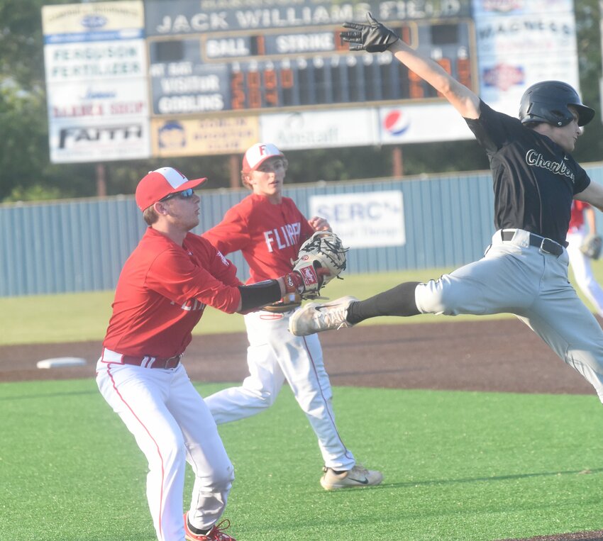 Flippin's Charlie Bailey puts a tag on Charleston's Ayden Kilpatrick down the first-base line on Thursday in the 3A Region 1 Tournament at Harrison.