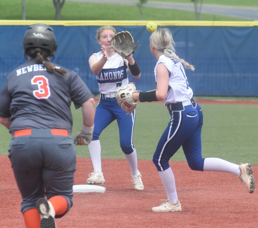 Mountain Home Diamonds Livy Smith (right) and Brooklyn Arms (middle) turn a double play on Saturday.