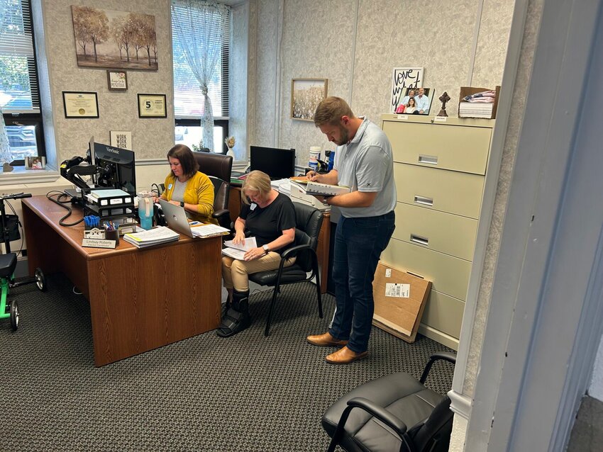 Phillip Frame Jr. (standing) completes his paperwork on Wednesday, July 31,  at the Baxter County Courthouse to be a candidate for the Ward 3, Position 1 seat on the Mountain Home City Council. Also pictured are (from left) Deputy County Clerk Gina Butterfield and Election Coordinator Lindsay Roberts. Frame was the first person to file in Baxter County and did not draw an opponent for the seat.


Submitted Photo