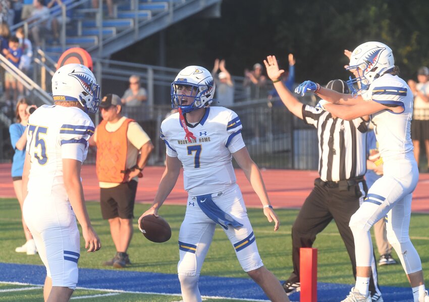 Mountain Home quarterback Brantlee Phillips (7) celebrates a touchdown during the Bombers' 30-14 win over Harrison on Friday night.