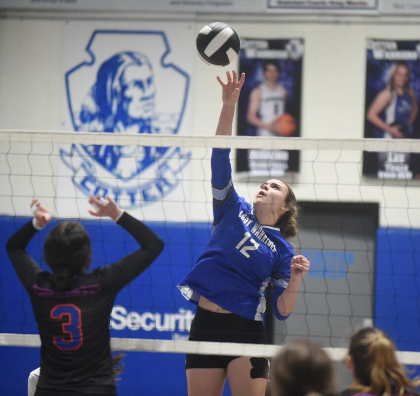 Cotter's McKenna Collins hits against Cedar Ridge during the Lady Warriors' three-set sweep Tuesday night.