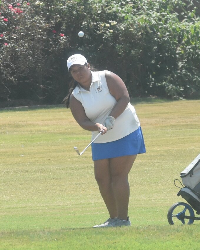 Mountain Home's Anna Torres pitches a shot onto the green during a recent home match at Big Creek Golf & Country Club.