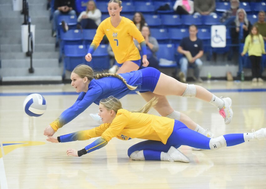 Mountain Home's Addison Martz dives over teammate Lauren Rauls for the ball during the Lady Bombers' loss to Valley View on Tuesday.