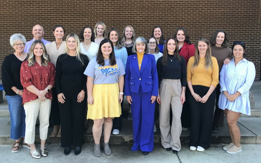 Former Mountain Home soccer coach Debbie Atkinson (front, middle) is pictured with several of her former players and assistant coaches from the 2009 and 2011 teams that she and her husband, Max, coached to state championships. Both teams were inducted Saturday into the MHHS Athletic Hall of Honor.