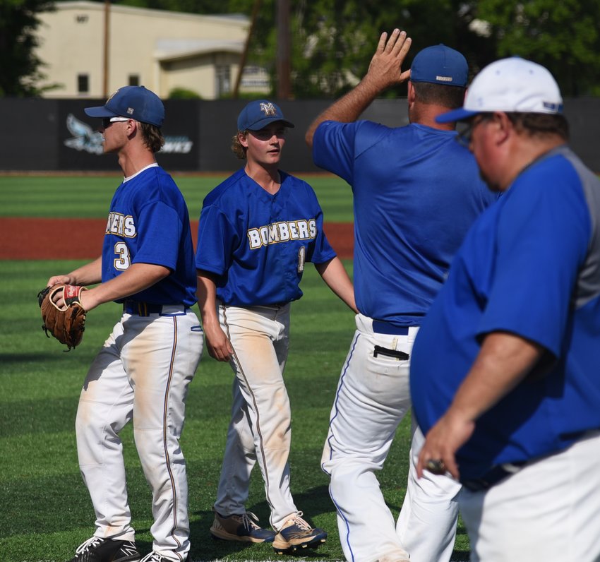 Teammates and coaches congratulate Mountain Home pitcher Jacob Czanstkowski after he worked a scoreless inning during Friday's state quarterfinal game against Sheridan.