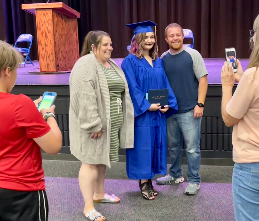 Kylie Christian was one of five students that graduated as part of Guy Berry College &amp;amp; Career Academy&rsquo;s night flight program. The commencement ceremony took place Thursday night at Mountain Home High School's Dunbar Auditorium. Pictured are: (from left) her moth,&nbsp;Casey Ives; Christian; and father, Brett Ives.&nbsp;   Helen Mansfield/The Baxter Bulletin
