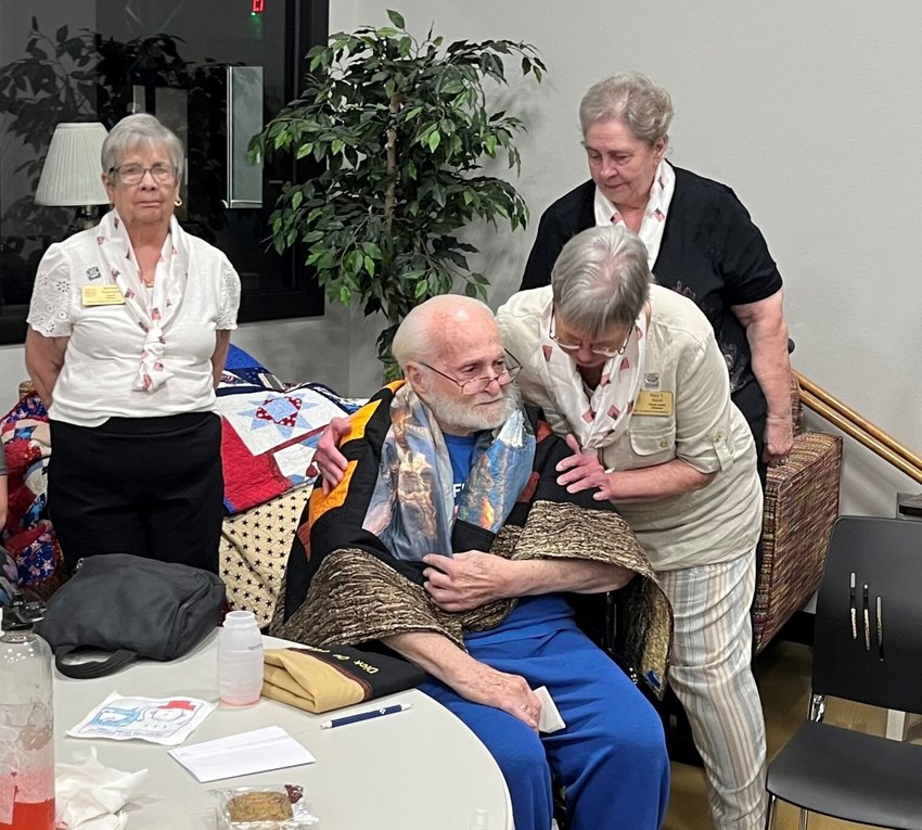 The Mountain Home Quilts of Valor group awarded its 200th quilt to guild member and Korean War Veteran, Richard Dupuis during the May meeting of the Hill &lsquo;N Hollow Quilting Guild at the Food Bank of North Central Arkansas.   Helen Mansfield/The Baxter Bulletin