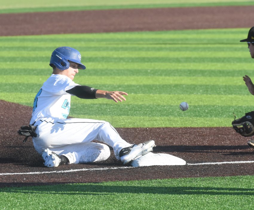 Lockeroom's Keegan Rickman slides into third base during the Mountain Home team's 7-5 win over Russellville on Saturday.