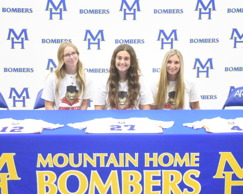 Mountain Home Lady Bomber soccer players (from left) Allison Guinn, Gisele Yousif and Sarah Vacco signed Wednesday to play at North Arkansas College in Harrison.
