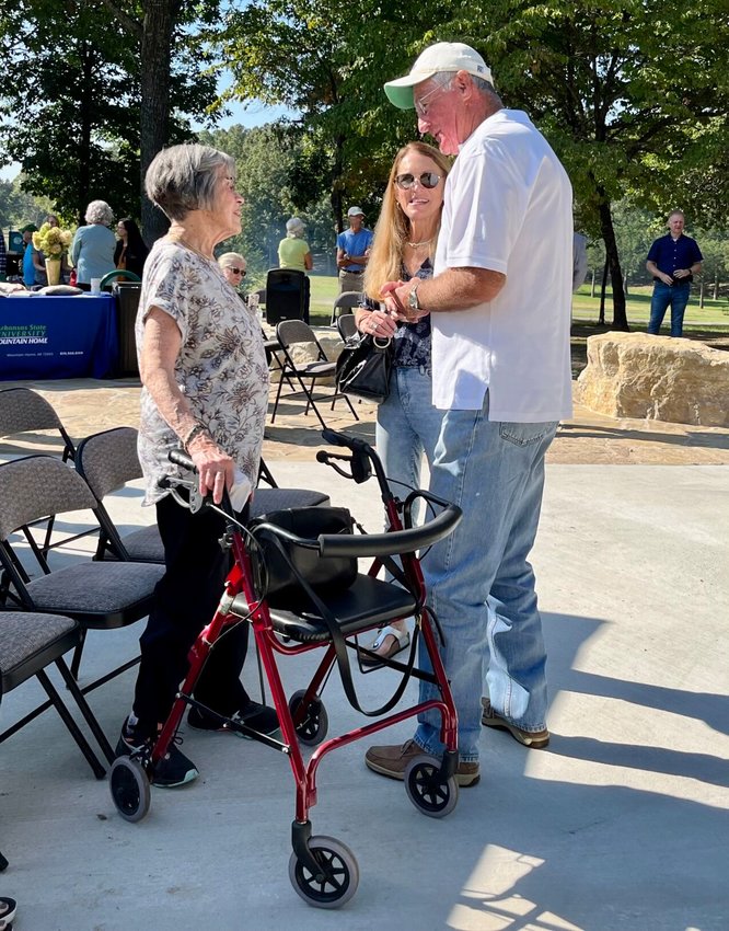 Sally Moore of Mountain Home (left) visits with Chancellor Emeritus Dr. Ed Coulter (right) during Thursday morning&rsquo;s dedication service. Sally and her three daughters attended the dedication ceremony of the recreation trail named after her late husband and herself.   Helen Mansfield/The Baxter Bulletin