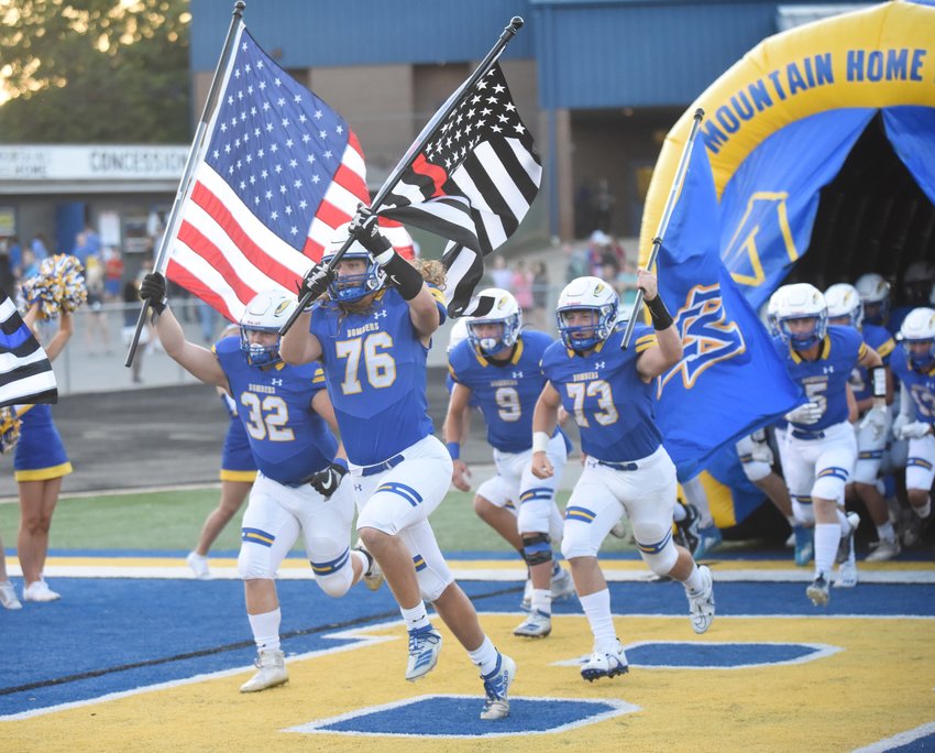 Mountain Home players run onto the field before last week's game against Lake Hamilton at Bomber Stadium.