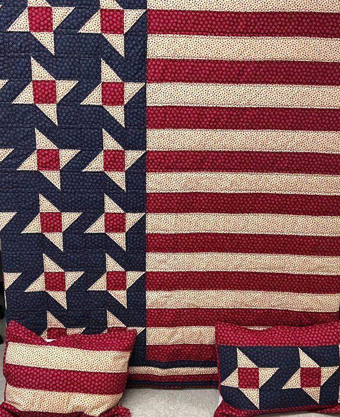 This quilted, queen-sized bedspread is on display in the foyer of Hackler Elementary School. Proceeds from the sale of this bedspread will benefit the EAST Veterans Lunch.   Submitted Photo