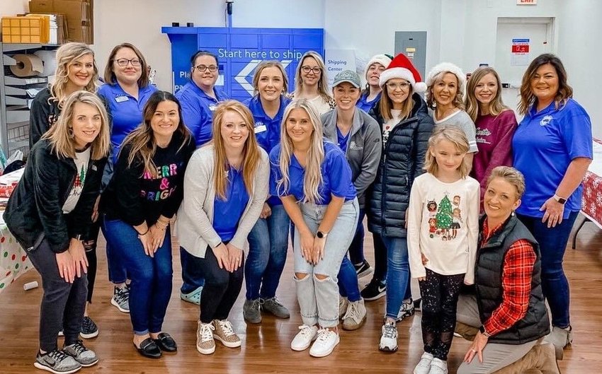 Roughly 15 members of the Junior Auxiliary of Mountain Home and 30 members of the Fraternal Order of Police (FOP) Lodge #45 provided food and presents last year for area students and their families. The annual For For Families/Shop With a Cop program will take place on Saturday, Dec. 3.   Submitted photo