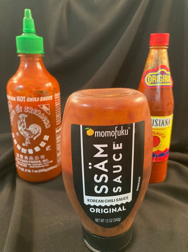 Spicy condiments and sauces can add zip to your favorite recipes. The three shown (from left) are Siracha, Gochujang and Louisiana Hot Sauce.   Linda Masters/The Baxter Bulletin