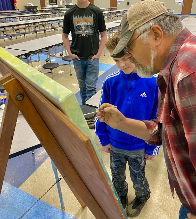 Local artist Duane Hada of Rivertown Gallery served as a special guest and artist Tuesday night as the students of Hackler Intermediate School participated in the first school-wide art show since 2019. Hada also recently created a mural of the Buffalo National River in the school&rsquo;s cafeteria.   Submitted Photo