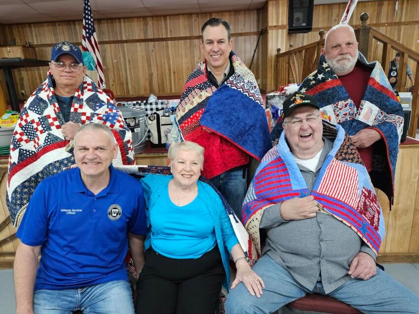 Pictured are the six veterans who were honored Saturday afternoon as part of the Baxter County Veterans Benefit Fair at the Baxter County Fairgrounds. Those receiving Quilts of Valor included: (first row, from left) Baxter County Veteran Service Officer and U.S. Air Force veteran Charles &ldquo;Charlie&rdquo; Leonard; Sharon Jones and Bob Jones, both U.S. Navy veterans; (second row) is U.S. Navy veteran Raymond Leonard; Paul Strack and Gil Reeder, both U.S. Army veterans.   Photo Submitted