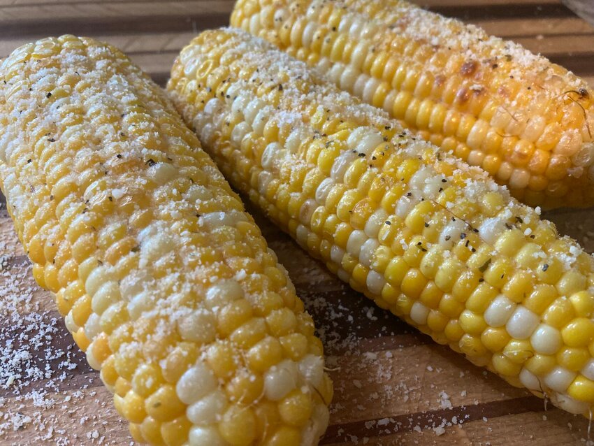 Fresh corn grilled and coated with garlic butter and sprinkled with fresh Parmesan cheese is a great way to start the summer grilling season.   Linda Masters/The Baxter Bulletin