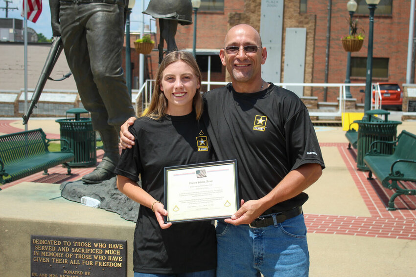 Pfc. Amelia Mason (left) is shown with her father, retired 1st Sgt. Lee Mason, after receiving an insignia from him Wednesday designating her rank at the Veterans Plaza in Mountain Home.   Ethan Granniss/Special to The Bulletin