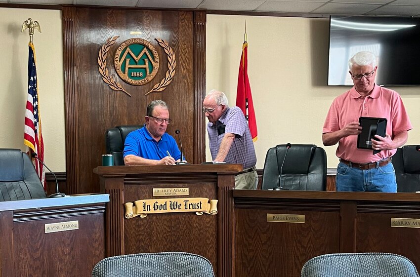Mountain Home Mayor Hillrey Adams (left) and councilmember Jim Bodenhamer discuss a topic during Thursday's Mountain Home City Council meeting. Also pictured is councilmember Carry Manuel.   Helen Mansfield/The Baxter Bulletin