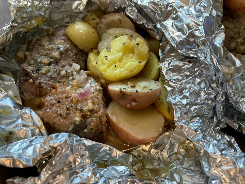 Garlic Butter Steak-and-Potato Packets can be assembled at home and transport in a cooler to eat when you arrive at your campsite or picnic or if the weather is bad, made in the oven.   Linda Masters/The Baxter Bulletin