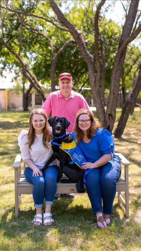 Matt Paden (from top), his daughter, McKenzie (left), and wife, Michele, pose with Roxy, a service dog trained through the Canine Companions program. The Padens will host a meet and greet event Monday from 1-4 p.m. at the Food Bank of North Central Arkansas in Mountain Home.   Submitted Photo