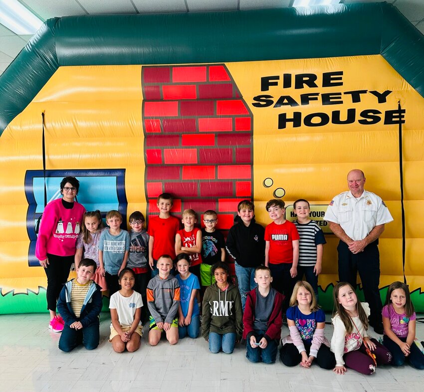 Mountain Home Fire Marshal Shawn Lofton (right) is pictured with students and faculty from Mountain Home Public Schools during National Fire Prevention Safety week activities this week in Mountain Home.   Submitted Photo