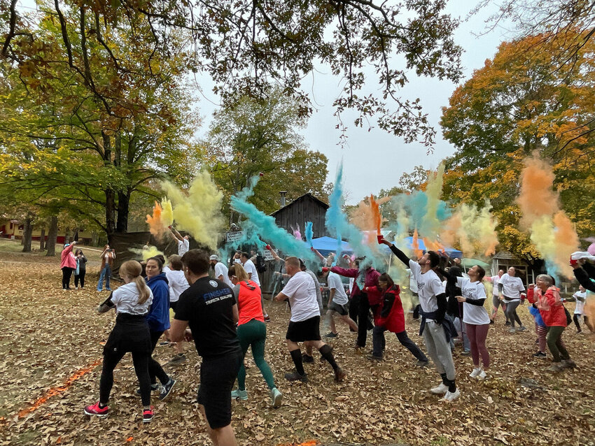 Participants launch chalk into the air at the start of the 2023 Colorama 5K color run/walk Saturday morning in Bull Shoals. Despite some rainy weather, the 2023 was judged a success according to those in attendance.   Samantha Hatley/The Baxter Bulletin
