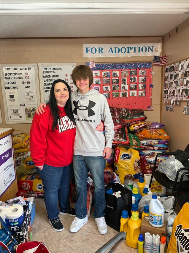 Stacey Adams Ferretti of Norfork and her son, Ryker, are shown with the items donated to assist pets last year. The Ferretti family lost 14-year-old Taylor in March of 2022 and conducted a donation drive in her memory during the holiday season.   Photo Courtesy of Stacey Adams Ferretti