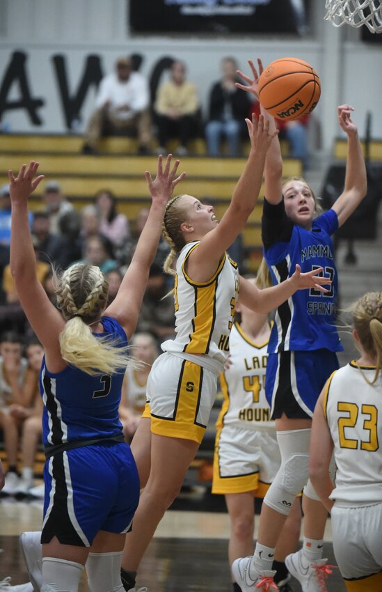 Salem's Marleigh Sellars puts up a shot over the reach of Mammoth Spring's Tay Davis during a game earlier this season. Salem and Mammoth Spring both earned wins in tournaments on Thursday.