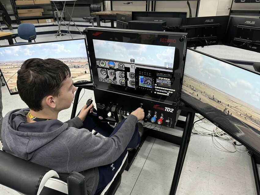 A Mountain Home High School aviation STEM curriculum student flies one of the FAA-certified flight simulators donated in 2023 to the schools by the Leading Edge Aviation Foundation.   Submitted Photo