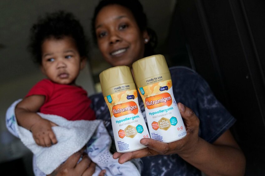 Ashley Yancey holds her 11 month-old daughter, Olivia, as she shows the last two cans of non-dairy formula she has at home in Douglasville, Ga. Researchers also found even greater reductions in the program&rsquo;s participation among individuals of minority race/ethnicity in addition to significant declines in WIC participation.   John Bazemore/AP Photo
