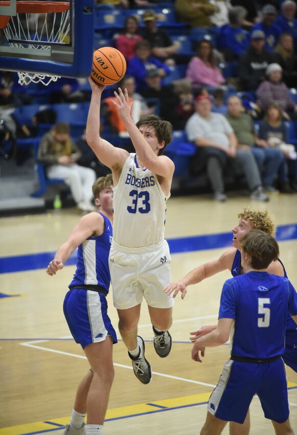 Mountain Home's Braiden Dewey (33) goes up for two during the first half of the Bombers' 62-45 victory over Greenbrier on Tuesday night.