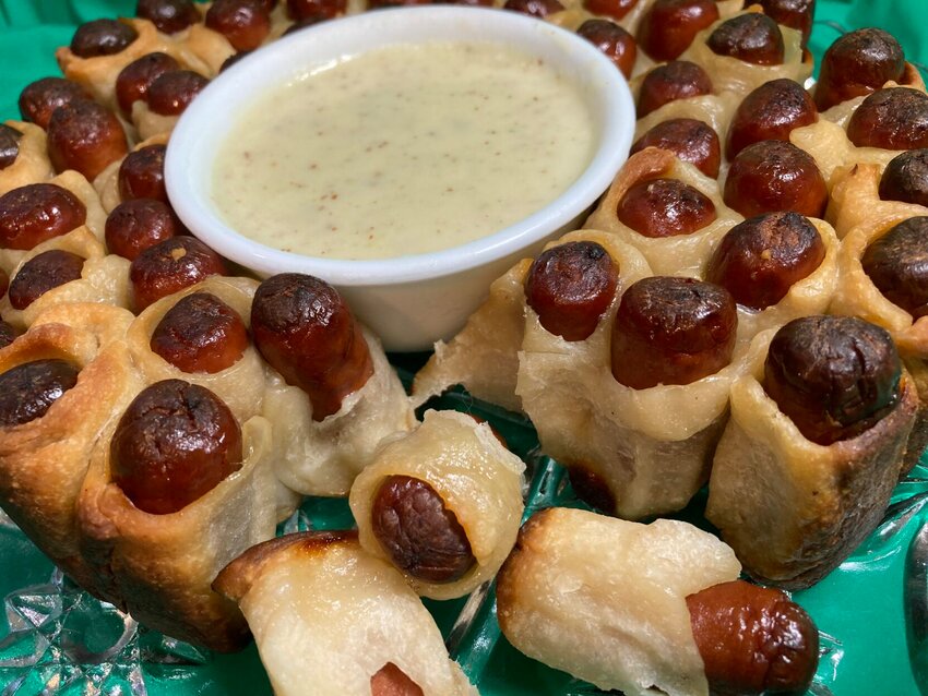 Shown are Pull Apart Piggies &mdash;&nbsp;pigs-in-a-blanket baked in a springform pan&nbsp;&mdash;&nbsp;served with Mustard-Cheese Sauce   Linda Masters/Baxter Bulletin