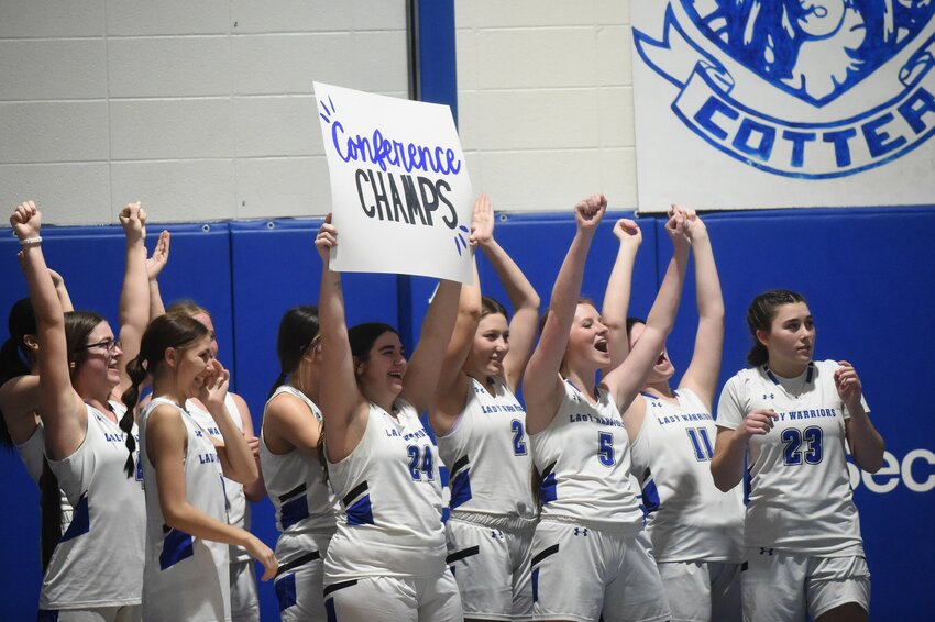The Cotter Lady Warriors celebrate after clinching the 2A-1 Conference championship last week. Cotter's girls won at Jasper on Tuesday to win their 13th straight game, tying the program record.