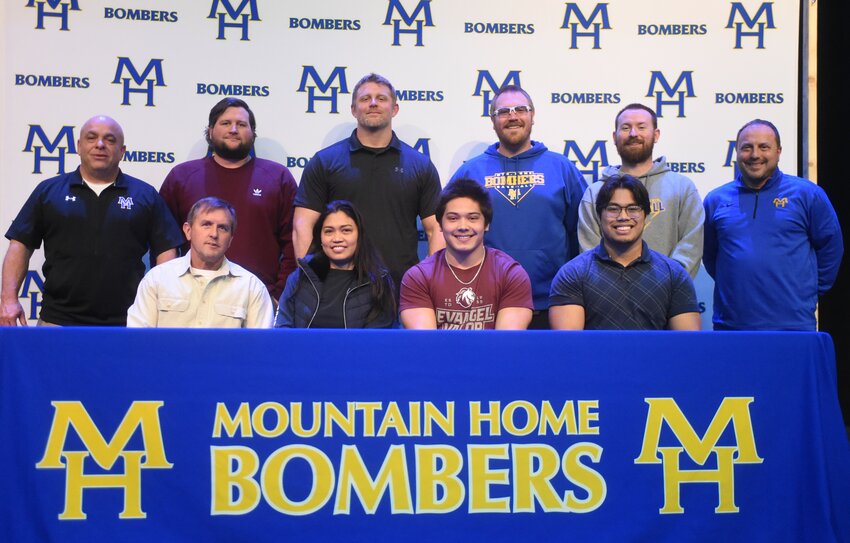 Mountain Home's Chris Hubbard signed Wednesday to play college football at Evangel University. Pictured are family (front row) Keith Reynolds, Edith Hubbard, Chris Hubbard, Charles Hubbard; (back row) coaches Steve Ary, Cale Thompson, Brett Shrable, Kyle Stephens, Blake Hendricks and Chris Cudworth.