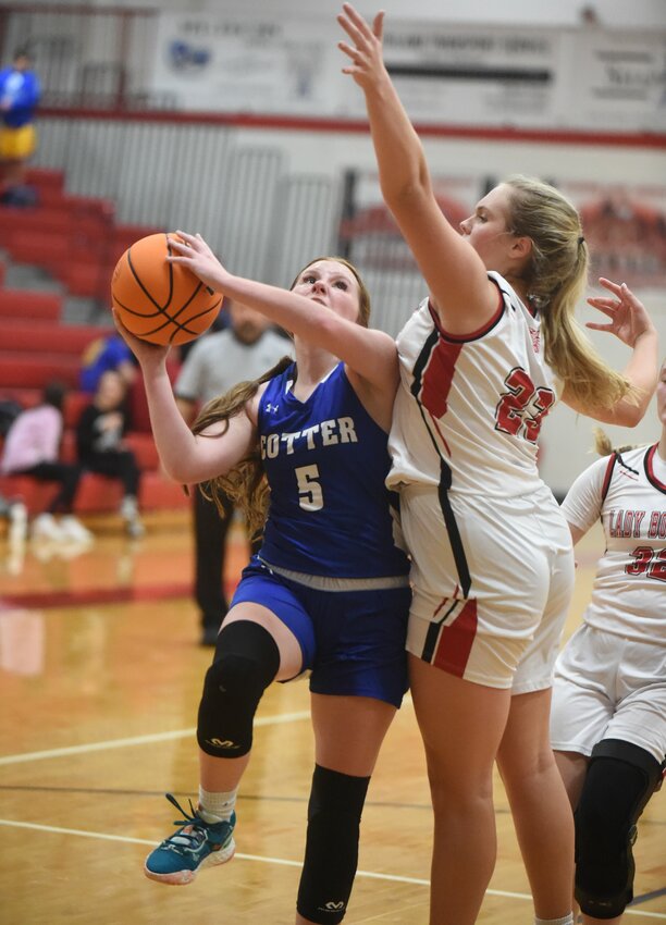 Cotter's Kylee Chastain goes up for a shot against Flippin's Kenna Greenhaw during a game earlier this season. Cotter picked up an easy victory at Lead Hill on Friday night with Chastain scoring 20 points.