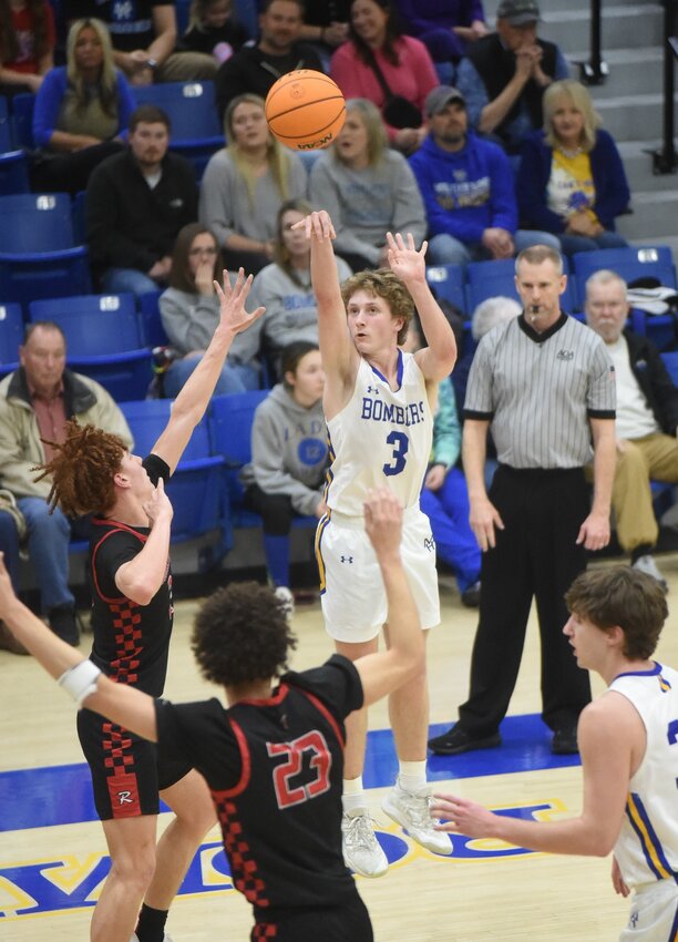 Mountain Home's McGee Harris launches a 3-pointer against Russellville on Tuesday night.