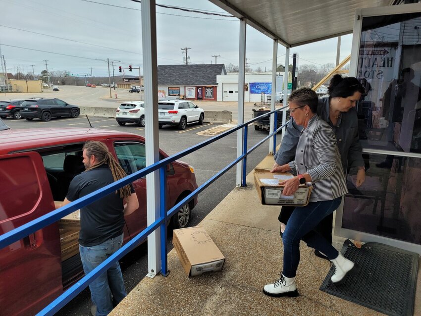 Teresa Smith, Baxter County collector, and Yvette Sigafus, Chief Deputy collector, handed off boxes filled with thousands of 2023 tax statements Friday morning to be taken to the northwest Arkansas USPS distribution center where they will be mailed out on Tuesday, Feb. 20.   Cole Sherwood/Baxter Bulletin