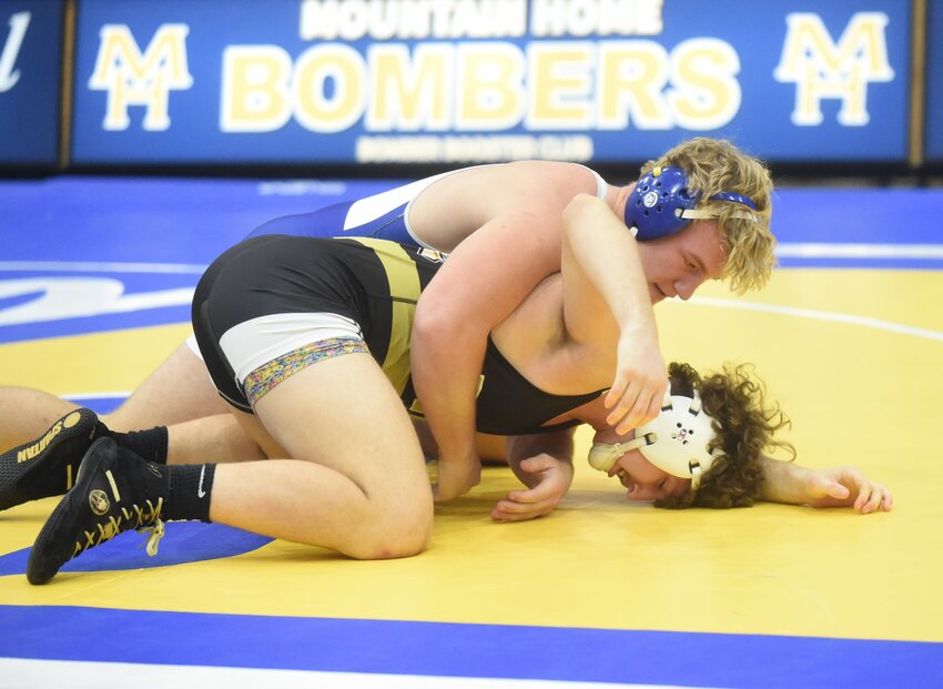 Mountain Home wrestler Noah Lagg controls his opponent during a recent home match. The Bombers placed third at the 5A-North Regional tournament Saturday at Searcy.