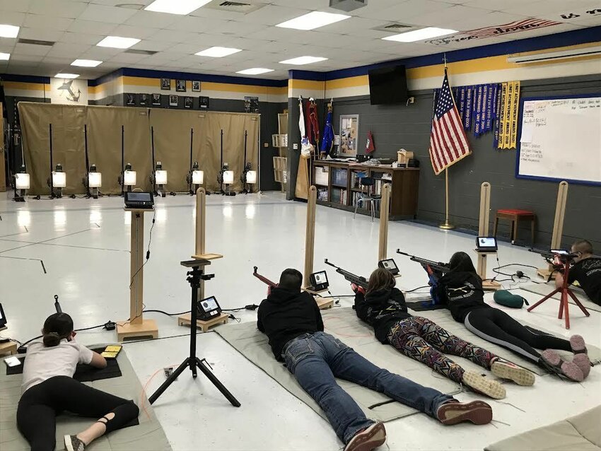 Navy Junior ROTC cadets (from left) Emerson Walls, Lukas Pool, Karhys Herbert, Aspen Douglas and Mak Smith are shown shooting prone on the Athena Scoring Target system.   Submitted Photo