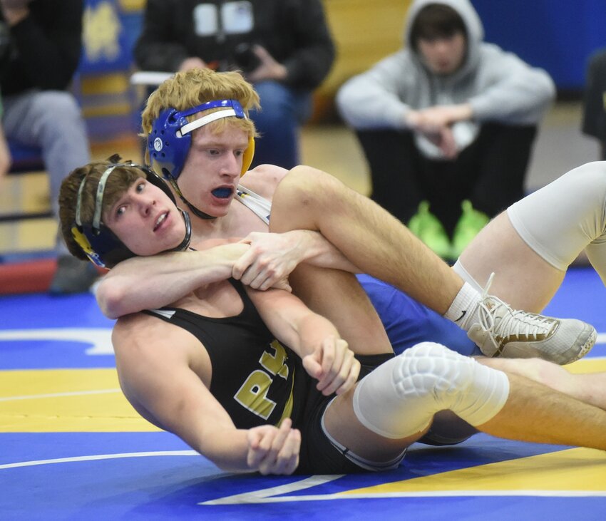 Mountain Home's James Wilburn controls his Pottsville opponent during a recent home match at The Hangar. Wilburn and teammate Isaiah Merry both won state championships in their respective weight classes on Saturday in Little Rock.