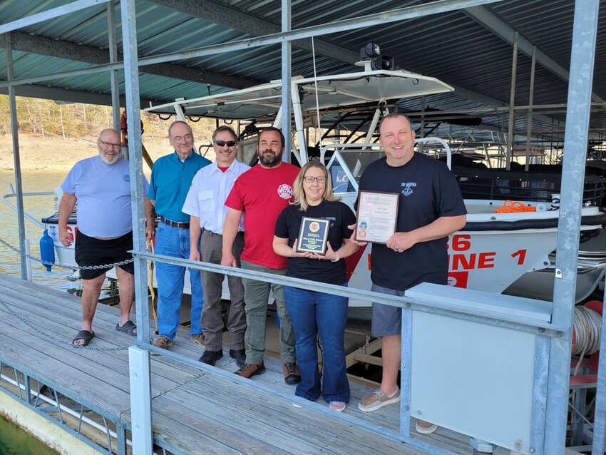 The 101 Gamaliel Volunteer Fire Department presents a plaque and certificate of appreciation to Joe and Kelly Bounce, owners of 101 Marina in Gamaliel, commending them for the marina&rsquo;s long standing service of housing the department&rsquo;s fireboat.   Cole Sherwood/Baxter Bulletin