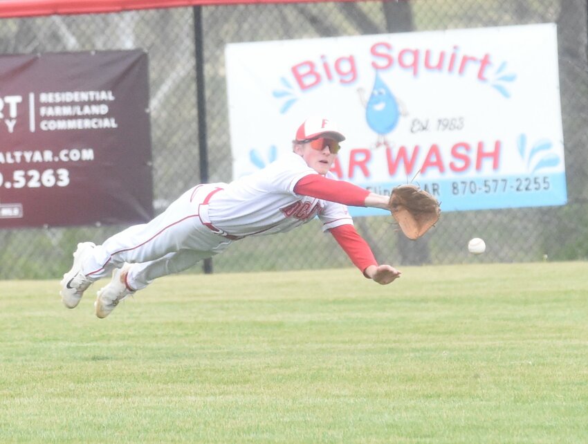 Flippin's Joseph Jackson dives for a ball in center field during the Bobcats' 16-6 win over Green Forest in the Forrest Wood Classic.