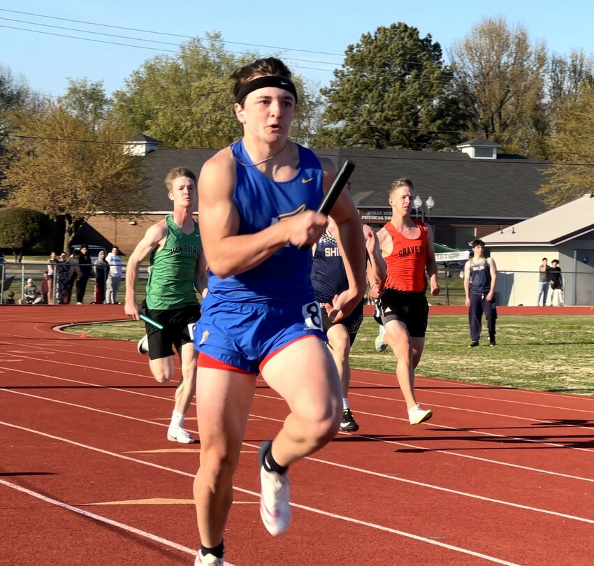 Mountain Home's Connor Schulz competes in a relay race on Thursday at Siloam Springs.