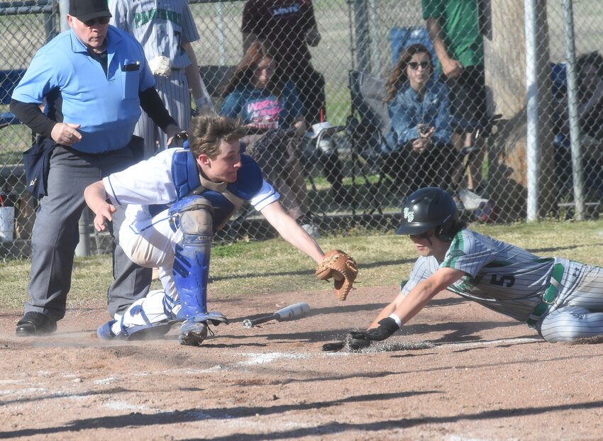 Cotter catcher Cole Tilton tags Yellville-Summit's Noah Cantrall at the plate during the Warriors' 6-2 victory on Friday.